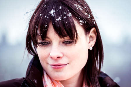 The young woman feels alone  She has snow in her hair and a lot of sorrows in her beautiful face の写真素材