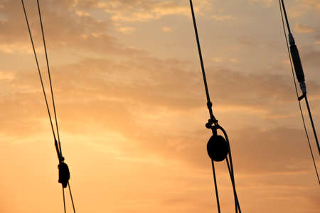 Afterglow with rope silhouettes  Romantic shipping scene  Let s go for an adventure tripの写真素材
