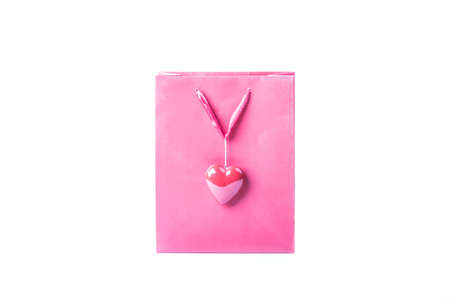 Pink love bag with a beautiful heart for Valentine's Day. Wonderful surprise for sweetheart wife or girlfriend. Isolated on white background.の写真素材
