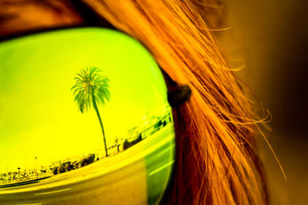 Vintage tropical luxury paradise beach palm glasses reflection. Exciting mirror imaging at sunglasses on head. Beautiful symbol of tourism vacation trip travelling to holiday dream island. Copypace.の写真素材