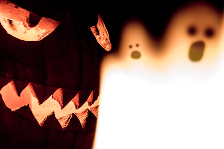 Carved spooky halloween pumpkin and scary mystery fire ghosts. Big helloween autumn symbol with mad...