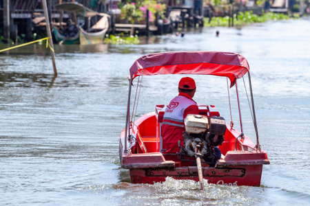 Ratchaburi, Thailand-April 14, 2018: Unidentified men selling Wall's ice cream using a boat.