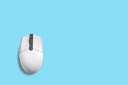 computer mouse on blue background, top view