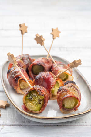 Green Brussels sprouts wrapped in smoked baconの写真素材