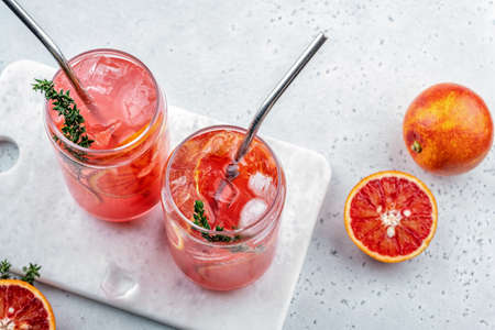 Blood Orange Margarita cocktail with ice and thymeの写真素材