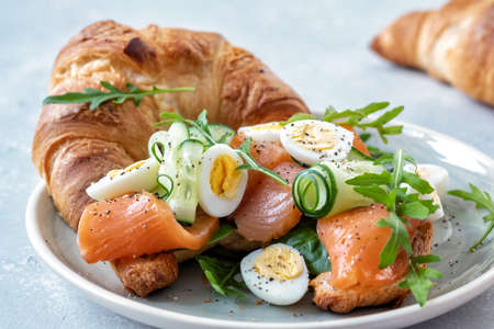 Croissant Sandwich with cucumber and salmonの写真素材