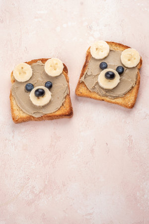 Funny children bear toasts with nuts butters for breakfast