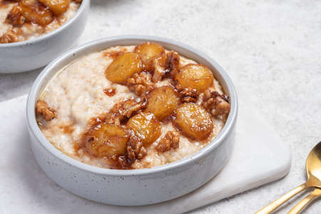 Porridge with caramelised banana and nutsの写真素材