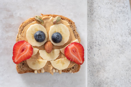Kids breakfast toast with peanut butter spread, banana, strawberryの写真素材