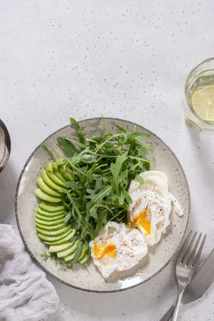 Healthy low carb breakfast. Poached eggs with avocado and arugulaの写真素材