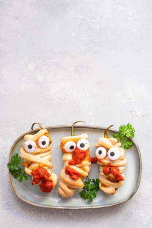 Stuffed peppers look like a mummies for Halloweenの写真素材