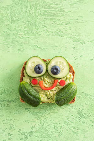 Funny Frog Toast With Cucumber And Mashed Avocadoの写真素材