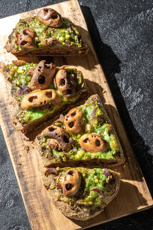 Halloween spooky pizza bread with skull-shaped mushroom.