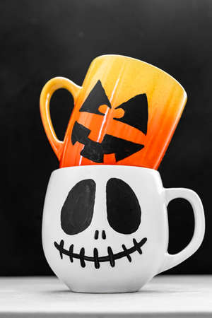 Mug with scary Jacks face. Halloween background.の写真素材