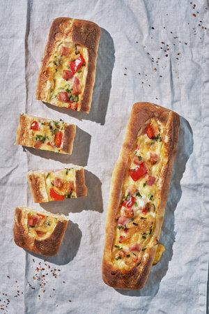 Bread boats stuffed with ham, egg and cheese for breakfastの写真素材