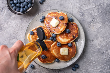 Buttermilk blueberry pancakes with maple syrupの写真素材
