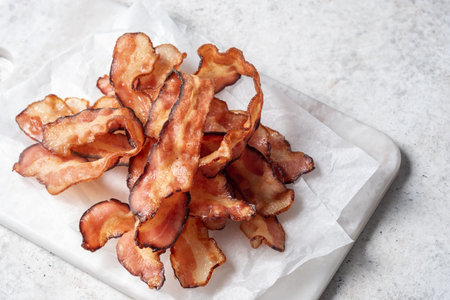 Cooked bacon rashers on parchment
