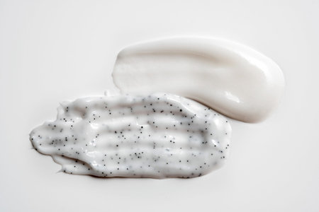 Various cosmetic smears on a white background, top view