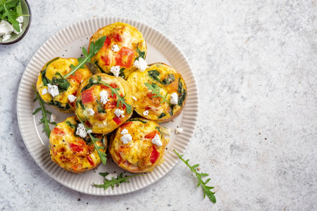 Delicious egg muffins with cheese and vegetablesの写真素材