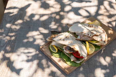 sandwich balik Ekmek with grilled fillet of mackerel, tomatoes, onions and lettuceの写真素材