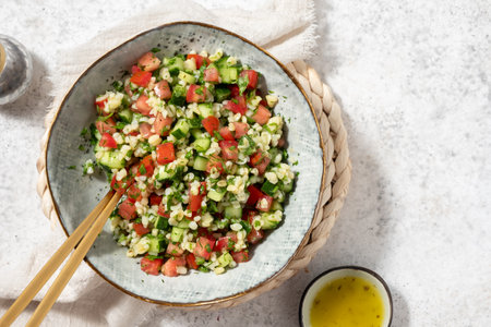 Tabbouleh salad. Traditional middle eastern or arab dish. Levantine vegetarian salad with parsley, mint, bulgur, tomato.の写真素材