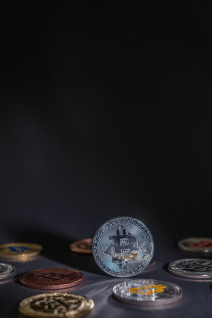 One coin of Bitcoin in silver color, standing on bitcoins coins, in a dark background. Bitcoin - BTC Bit Coin - Crypto currency.の写真素材