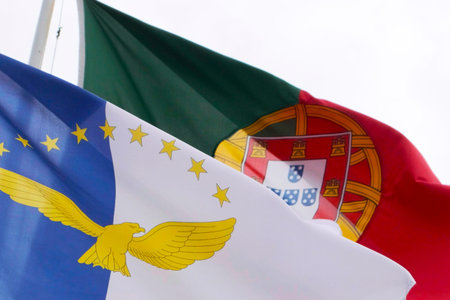Azores and Portugal Official Flags bouncing in the air on a windy day, SÃ£o Miguel Island, Azores....
