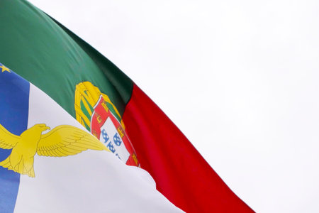 Azores and Portugal Official Flags bouncing in the air on a windy day, SÃ£o Miguel Island, Azores. Azorean and Portuguese Flag flying on the air.の写真素材
