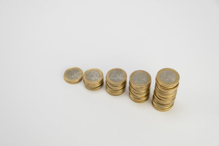 One Euro Coins stacked on a white background. Top view perspective. Money coins saving concept side view. Copy space.の写真素材