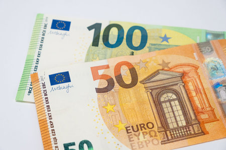 Fifty euro banknote and in the background one hundred euro banknote. Closeup on a white background....