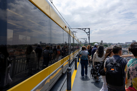 Porto, Portugal - 31.05.2023: Porto Metro Line, on the upper deck of the Luiz I Bridge with lot of...
