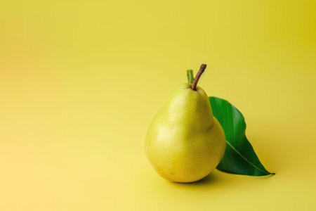 Ripe yellow pear with green leaf on yellow background, copy space. Generative AIの素材