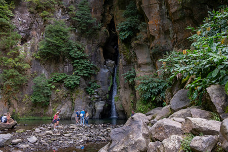 Ribeira Grande, Azores - 05.09.2019: Tourists standing near the beautiful "Salto do Cabrito" Waterfall. Sao Miguel island in the Azoresのeditorial素材