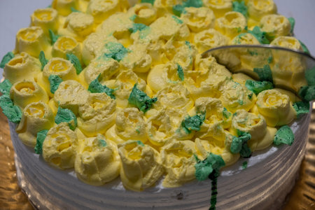 Cake decorated with yellow and green butter cream, closeup.