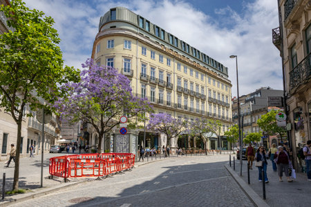 Porto, Portugal - 31.05.2023: Downtown streets of Porto with people, and the Brazilian Hotel building (A Brasileira) in the background in the city of Porto in Portugal.のeditorial素材