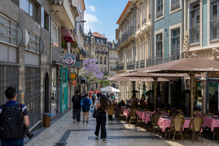 Porto, Portugal - 31.05.2023: Street view of the old town of Porto in Portugal, with tourists, restaurants, shops and beautiful old buildings.のeditorial素材