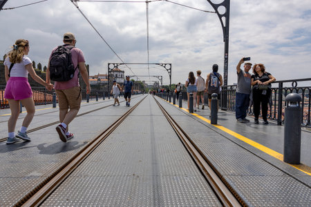 Porto, Portugal - 31.05.2023: Many tourists walking on the top deck of the Bridge D. Luiz I in the city of Porto in Portugal.のeditorial素材