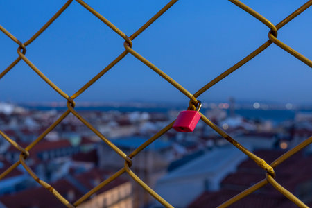 Padlock on a chain link fence in Santa Justa Elevator (Elevador de Santa Justa) Lisbon, Portugalの写真素材