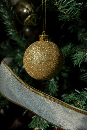 Golden bauble on Christmas tree. Copyspace.の写真素材