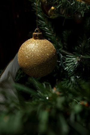 Close up to Golden bauble on Christmas tree. Copy Space.