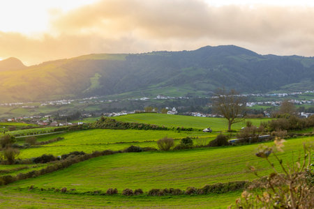 Beautiful rural landscape, with green fields at dusk on a cloudy day. Povoacao Island of Sao Miguel,...