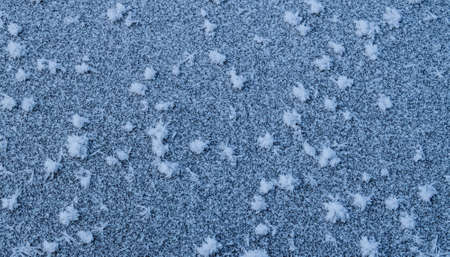 blue ice covered with snowflakesの写真素材