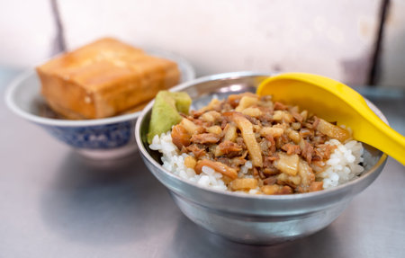 The taiwan traditional cuisine,braised pork rice ,pickles and fried tofu. It can be easily found in...