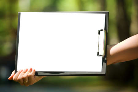 The clipboard with the white sheet of paperの写真素材