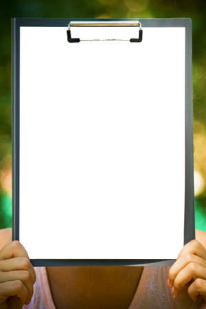 The clipboard with a sheet of paper in handsの写真素材