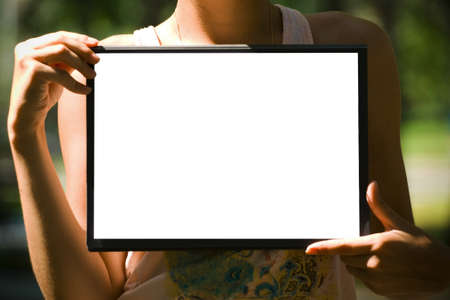 The white sheet of paper on the clipboard in handsの写真素材