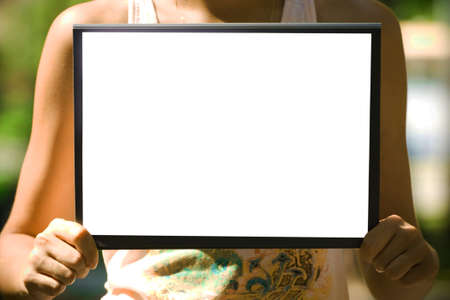 The white sheet of paper on the clipboard in handsの写真素材