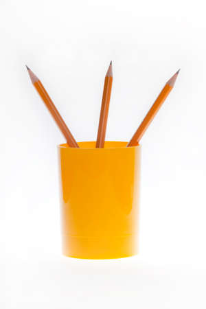 pencils in yellow cup for pencils on the white backgroundの写真素材