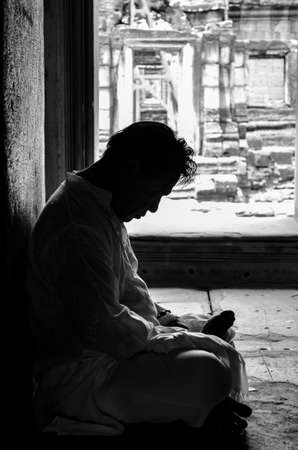 meditation by man silhouette in old templeのeditorial素材