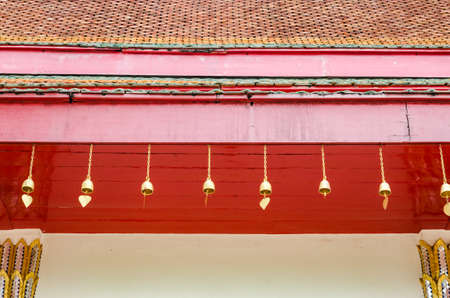a small bell hanging under the temple roof at the marble templeの写真素材